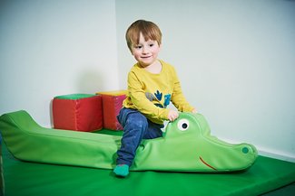 Soft Play City boy on crocodile soft toy