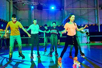 Mixed teenage group skating at an exclusive party