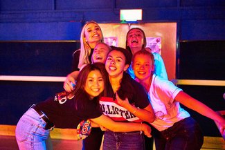 Teenage group at roller skating party