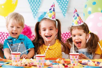 Three children enjoying a party
