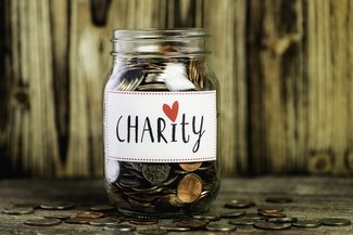 Jam jar with coins and Charity label