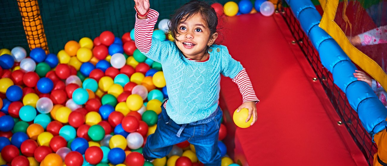 Girl in ball pit at Soft Play City